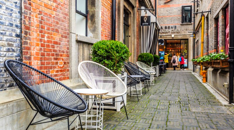 cafes in colchester town centre showing independent coffee shop with outdoor seating on cobbled street near colchester castle