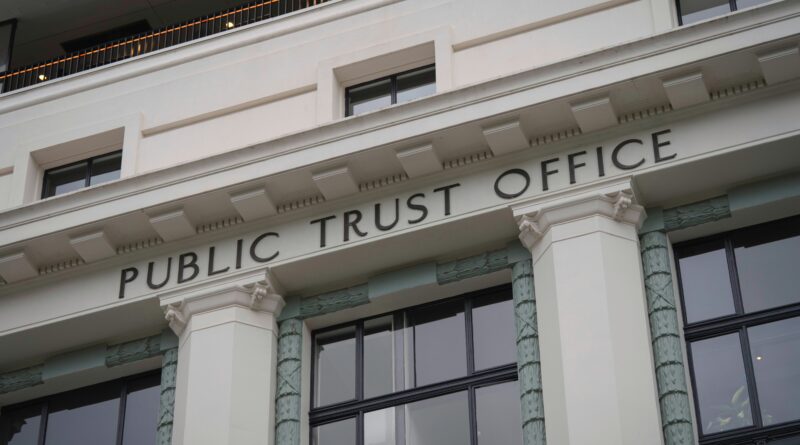 establishing trust fund uk showing solicitor reviewing trust deed documents with clients at desk with family home photo and financial papers