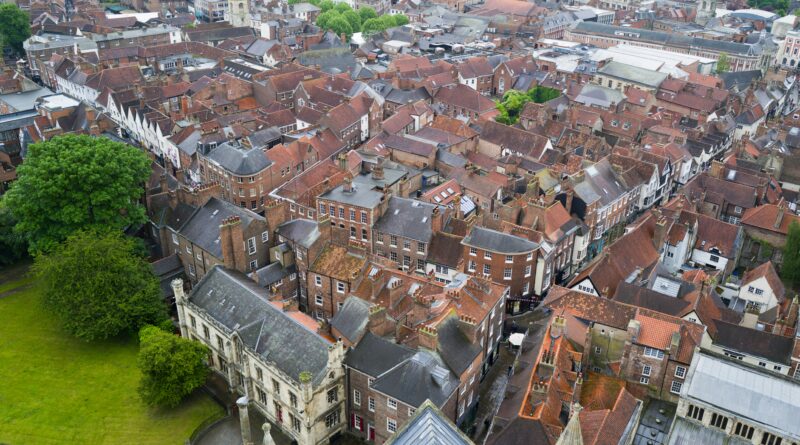 places to stay in york england showing boutique hotel room with view of york minster through window at dusk
