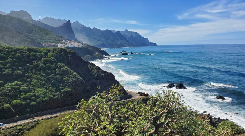 things to do in Tenerife showing the dramatic volcanic landscape of Mount Teide National Park with the snow-capped Teide volcano rising above the clouds representing the top attraction and things to see in Tenerife Canary Islands