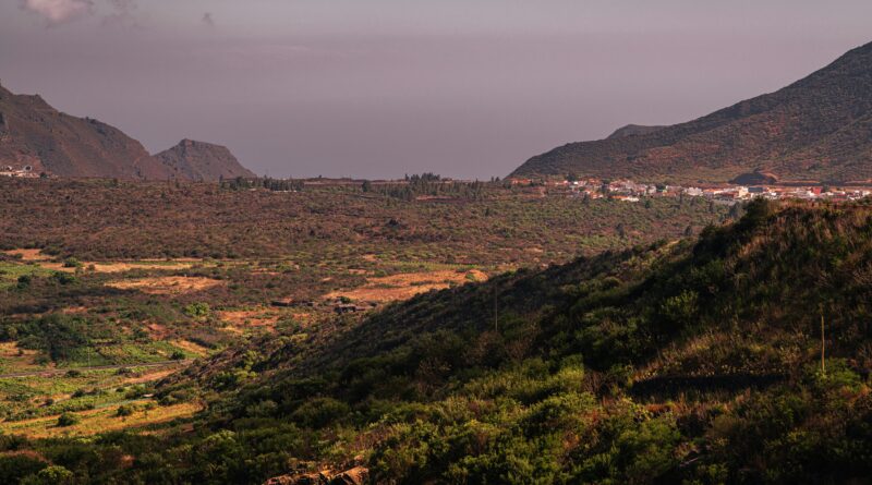 things to do in Tenerife South showing the dramatic Los Gigantes cliffs rising 800 metres above the Atlantic Ocean with a boat in the turquoise water below representing the top attractions in southern Tenerife Canary Islands