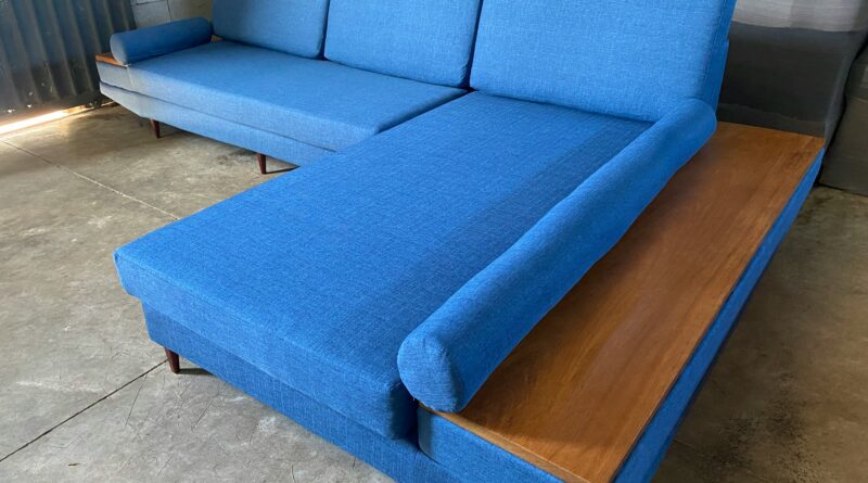 sofa bed with storage showing a grey corner sofa bed with open storage compartment in a modern living room representing the best sofa beds with storage for small spaces and guest rooms in the UK