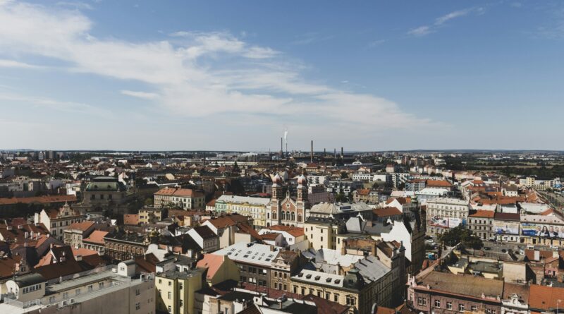 Pilsen Czech Republic Republic Square Namesti Republiky showing the Gothic Cathedral of St Bartholomew and pastel Renaissance town hall facades in the main city square