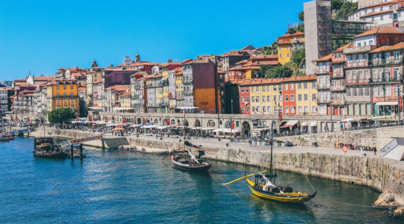 things to do in Porto Portugal showing the iconic colourful tiled buildings of the Ribeira waterfront district with the Dom Luis I bridge and the Douro River representing the top attractions and things to see in Porto