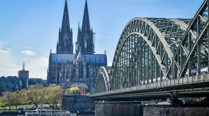where to stay in Cologne Germany showing the iconic Cologne Cathedral Koelner Dom rising above the Altstadt old town with the Rhine River in the background representing the best area to stay in Cologne