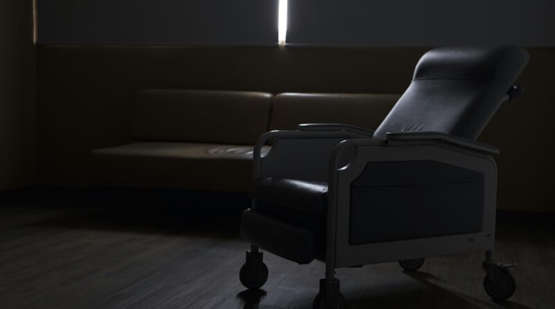 rise and recline chairs showing a person using an electric riser recliner armchair in an assisted standing position representing how these chairs support mobility at home