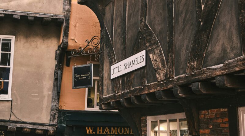 places to eat in york showing a cobbled street in york city centre lined with independent restaurants and cafes representing the best places to eat in york