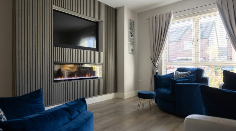 electric fire and surround showing a freestanding electric fire suite with a wooden mantel surround in a living room representing how to choose a matching fire and surround