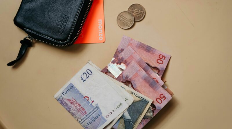 cost of living payment 2025 when will it be paid universal credit showing person checking DWP Universal Credit statement on mobile phone at home