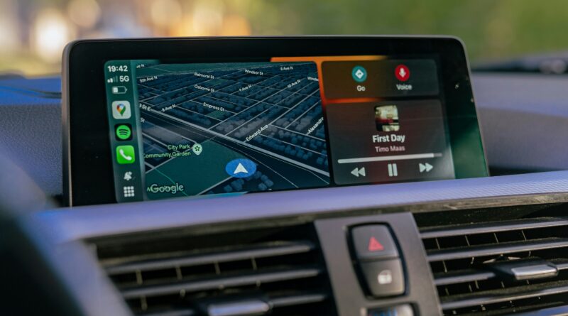 carplay android showing a car dashboard infotainment screen running Android Auto and Apple CarPlay representing the difference between carplay and android auto for UK drivers in 2026