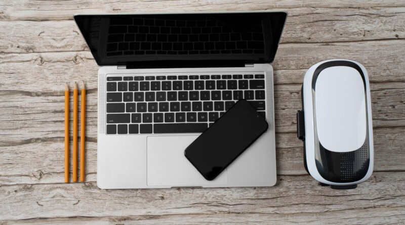 best MacBook accessories UK showing a MacBook Air with keyboard mouse hub and charger representing best accessories for MacBook Air and Pro UK 2026